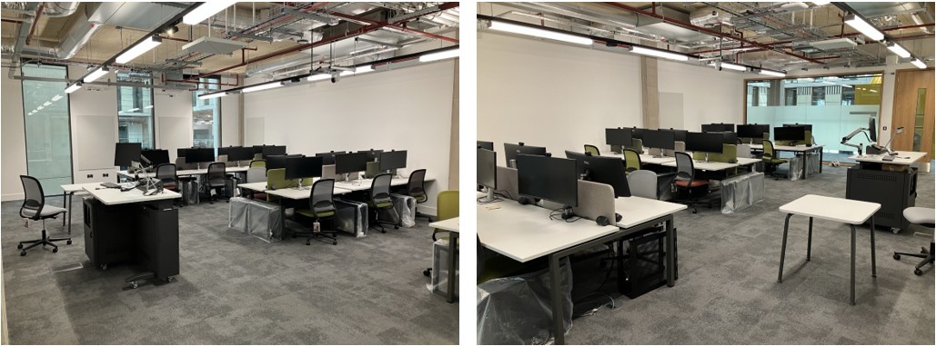 Classroom with desks and chairs with a monitor and computer at each desk.